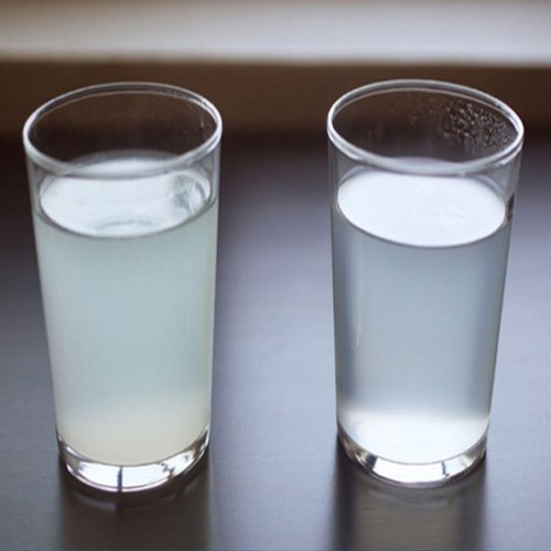 Two glasses of water side by side, one cloudy and one clear